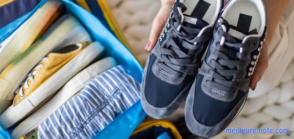 Une femme qui met ses baskets dans un sac de rangement bleu