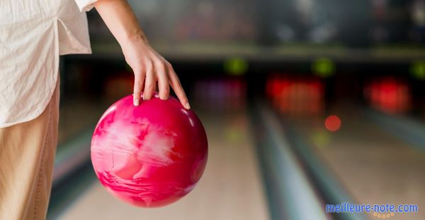 Un homme qui tient la boule de bowling