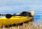 canoé jaune sur le bord d'un lac avec 2 rames