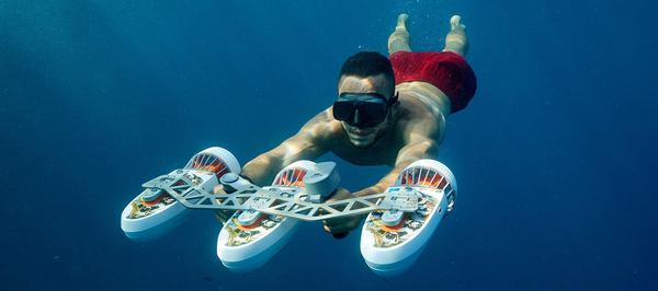 un homme explore avec un scooter sous marin